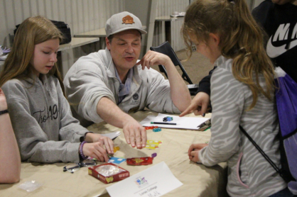 Students playing dice and cards.